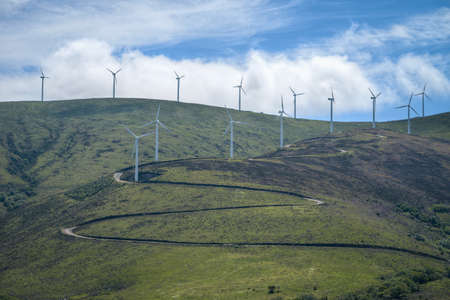 Curved road in a wind farm in the mountains of Lugo Galicia