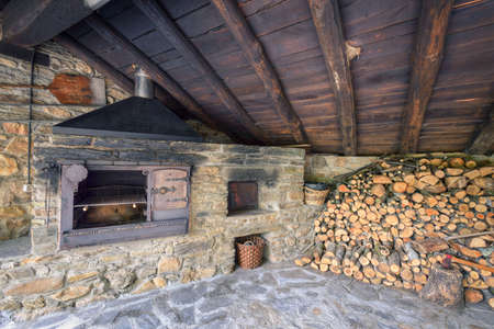 Grill and stone oven next to a woodshed in a building attached to a typical Galician rural houseのeditorial素材