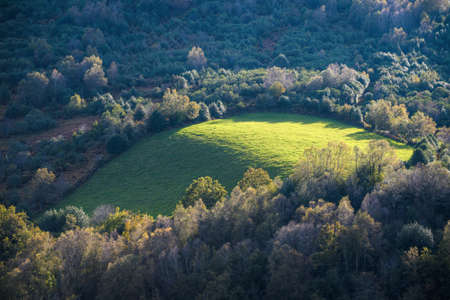 Oval shaped meadow delimited by native forests and expanses of heather in Courel Mountains Geopark...
