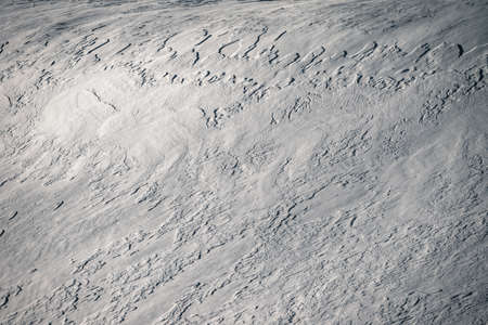 Abstract background of patterns formed by the wind on the snow in Ancares in Galicia