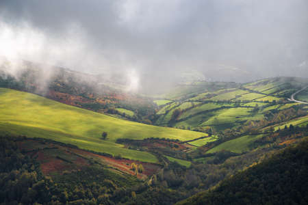 Landscape of bright rolling green countryside with some mist in Courel Mountains Geopark in Galicia