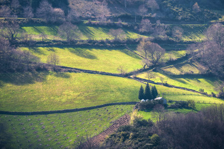 A small rural chapel with a cemetery among pastures in Cervantes Ancares Galiciaの写真素材