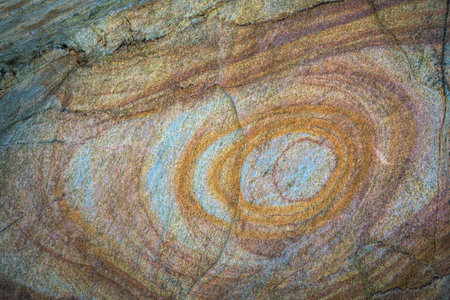 Iron deposits form concentric rings in the sandstone rock on a beach in O Vicedo Lugo Galiciaの写真素材