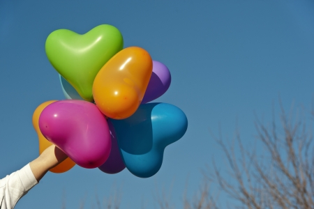 Blue cloudy sky with balloons, as valentines background の写真素材