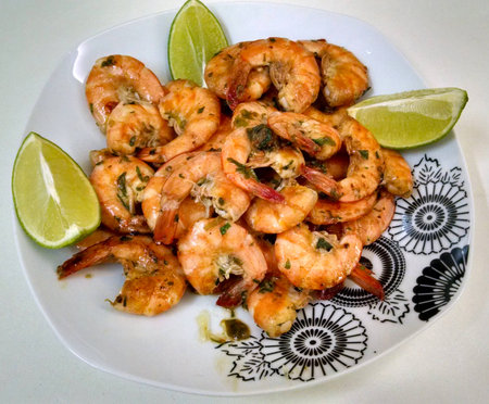 Fried shrimp with lemon portion cut into pieces.の写真素材