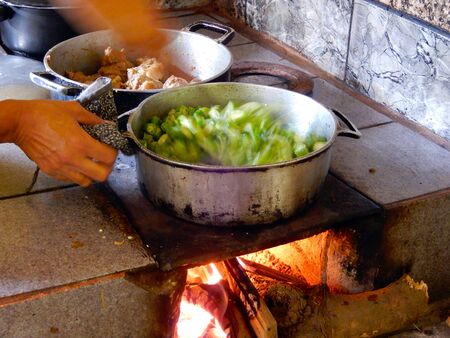 Cooking okra on the wood stoveの写真素材
