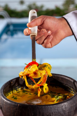 Shrimp and fish moqueca with vegetables, coriander and palm oil