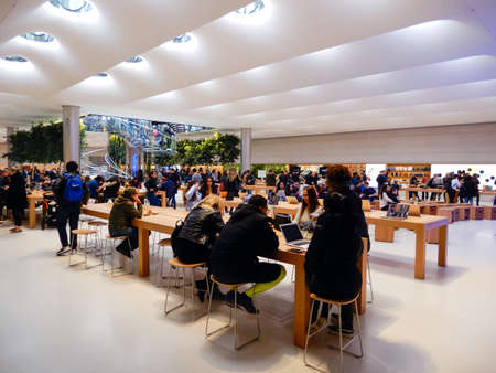 NEW YORK - FEBRUARY, 2020: People visiting the Apple Store on 5th Avenue. Apple Inc. is an American multinational technology company headquartered in Cupertino, California.のeditorial素材