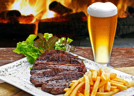 Sliced Picanha with French Fries and Beerの写真素材