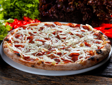 Pepperoni pizza with onion ringsの写真素材