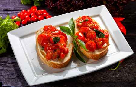 bruschetta with cherry tomatoes and basilの写真素材