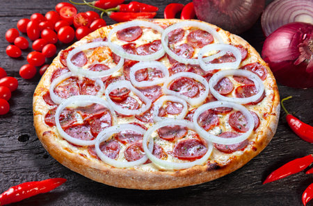 Pepperoni pizza with onion ringsの写真素材