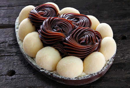 Brazilian easter egg stuffed with chocolate and cream, tasted with a spoon. Easter tradition in Brazilの写真素材