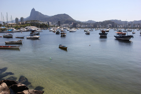 Rio de Janeiro, Brazil, 12 September, 2016: Christ the Redeemer statue is seen from Urca, place used as small fishing boats dock. Despite being bathed by the waters of Guanabara Bay, the water was crystal clear and at some points you could see fish swimmiのeditorial素材