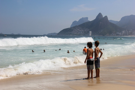 Children observe the Ipanema beach, in Rio de Janeiro.の写真素材