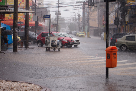 After a very hot day, with temperatures rising from 35 degrees Celsius, heavy rain hit some parts of the city of Rio de Janeiro.  With the rain, the streets of the neighborhood were partially flooded and many people ended up wet with the unexpected rain iのeditorial素材