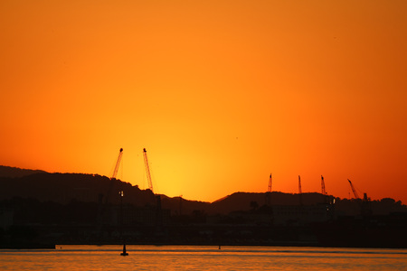 Rio de Janeiro, Brazil, July 14, 2017: View of the sunset in winter afternoon in the port area of Rio de Janeiro. Cariocas and tourists watch the sun set on the shores of Guanabara Bay, in the center of Rio. Despite winter, temperatures in the city are inのeditorial素材
