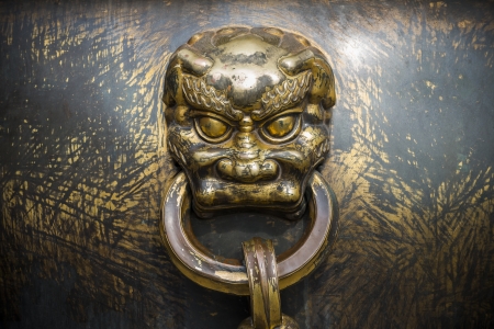 beast head on a huge copper jarの写真素材
