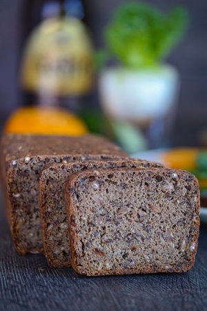 A loaf of bread and two slices of bread are placed on a table, showing the versatile use of this...