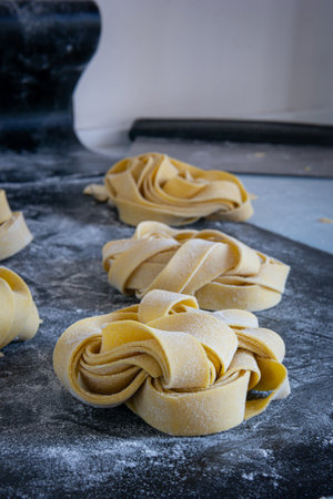 Three pasta pieces on table, awaiting to be cooked into a delicious dishの写真素材