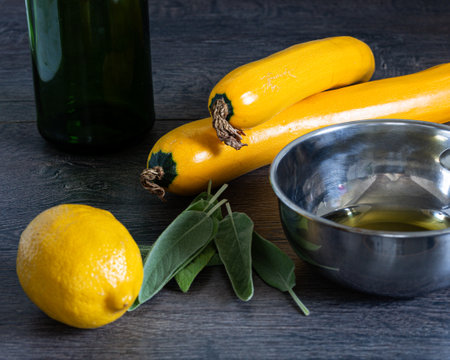 Ingredients on table sweet lemon, zucchini, olive oil, for delicious recipeの写真素材