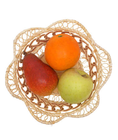Fruit a pear, an orange, an apple in a wattled plate on a white background.                   の写真素材