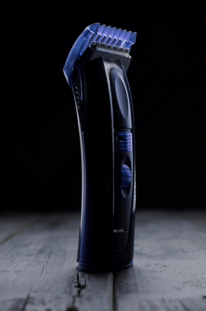 Blue Electric shaver on black wood boards still life. Selective focus.の写真素材