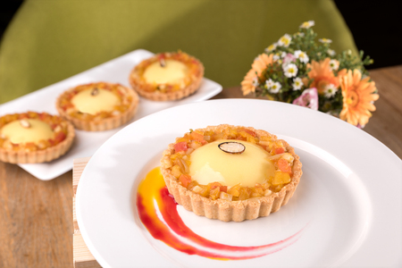 Homemade exotic tart - passion fruit ganache, lime curd, exotic marmalade, coconut biscuits.の写真素材