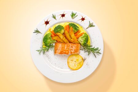 Salmon with curry sauce and fresh vegetables served in a plate. Top view. Food from above.の写真素材
