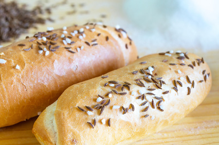 A pair of bread rolls on wooden tableの写真素材