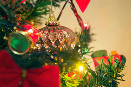 Detail of christmas tree decoration. Merry Christmas and happy New Year, 24th of December. Close up view of Christmas tree twig with ornamentsの写真素材