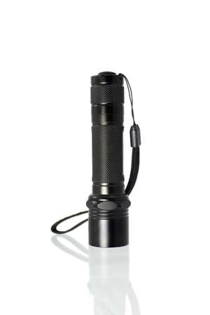 Pocket metal LED flashlight isolated on white background. Close up of standing aluminium battery powered flash light, studio photoの写真素材