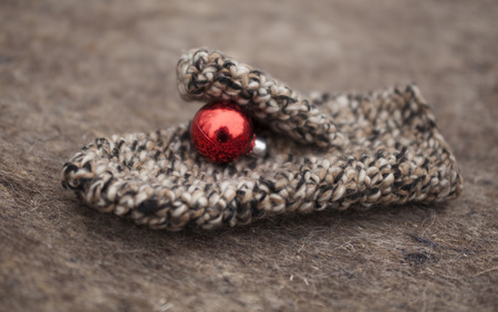 Mitten with a Christmas toy on the background felt