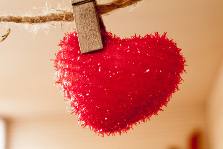 red heart which hangs on a rope hairyの写真素材