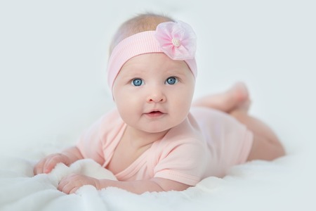 Portrait of adorable baby girl in pink dress.の写真素材