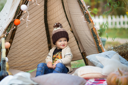 Child in autumn park. Happy adorable boy with fall leaves.の写真素材