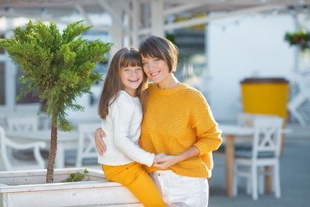 Mother and little daughter having fun in a park on a nice sunny day.の写真素材