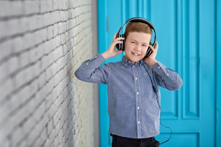 Relax and listening music concept. European boy fill the bit. Portrait of head in headphones with...