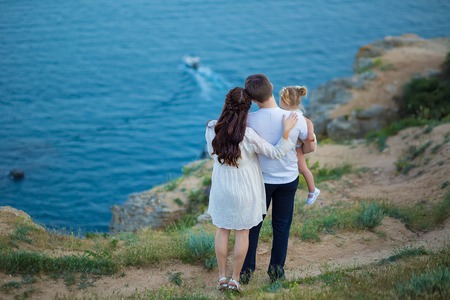 Couple family traveling together on cliff edge man and woman lifestyle concept summer vacations outdoor Crimean mountain topの写真素材