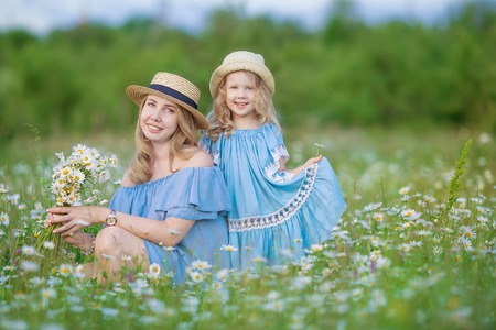 beautiful girl on the daisy flowers fieldの写真素材