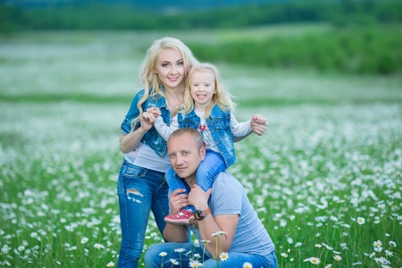 happy family having fun outdoors. Portrait of happy family in countryside. Happy people outdoors wearing jeans enjoying time together.の写真素材