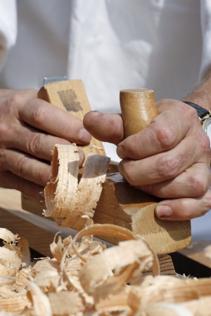 Close-up of carpenter s hands with bench plane at workの写真素材