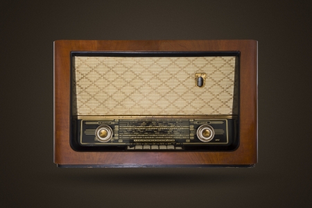 Picture of an old vintage, wooden radio isolated on brown background with noise.の写真素材