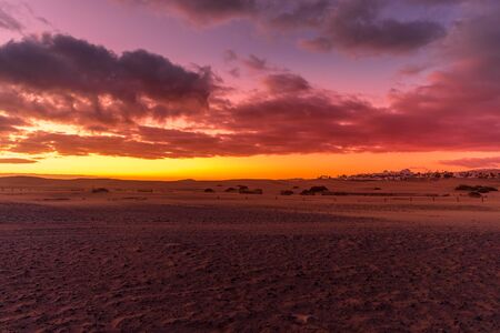 Sunrise from a cliff with moving clouds in a different direction forming a line where the sun rises...