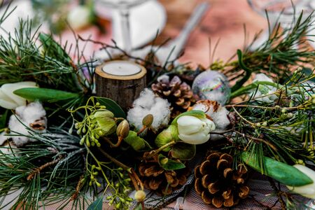 Wedding old wooden table with a flower-filled decoration and placement with glasses at a wedding ceremony in winter on snow in the middle of a forest covered with fresh snow...の写真素材