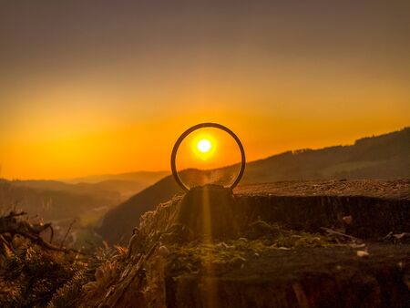 Taking photos of sunset through the camera filter inside nature.の写真素材