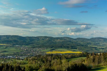 Landscape with lots of clouds in the mountainous area of the Beskydy Mountains during a sunny afternoon.の写真素材