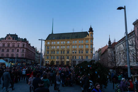 BRNO, CZECH REPUBLIC - NOVEMBER 30, 2018:Moravske namesti (square) during Christmas for event for set up the Christmas tree on square huge crowd people and public transport in background Christmas decoration on surrounding buildings...のeditorial素材
