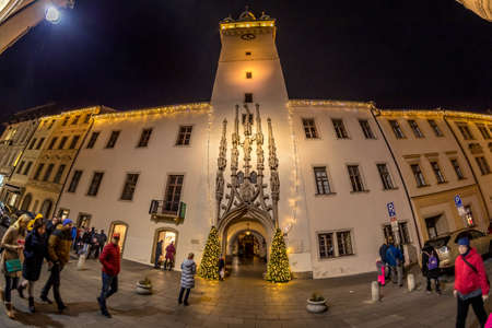 BRNO, CZECH REPUBLIC - DECEMBER 8, 2019: Christmas lights at the old town hall during the classic Christmas market, wide shot of 180 degrees view of the illuminated building.のeditorial素材