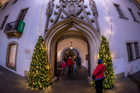 BRNO, CZECH REPUBLIC - DECEMBER 8, 2019: Christmas lights at the old town hall during the classic Christmas market, wide shot of 180 degrees view of the illuminated building.のeditorial素材